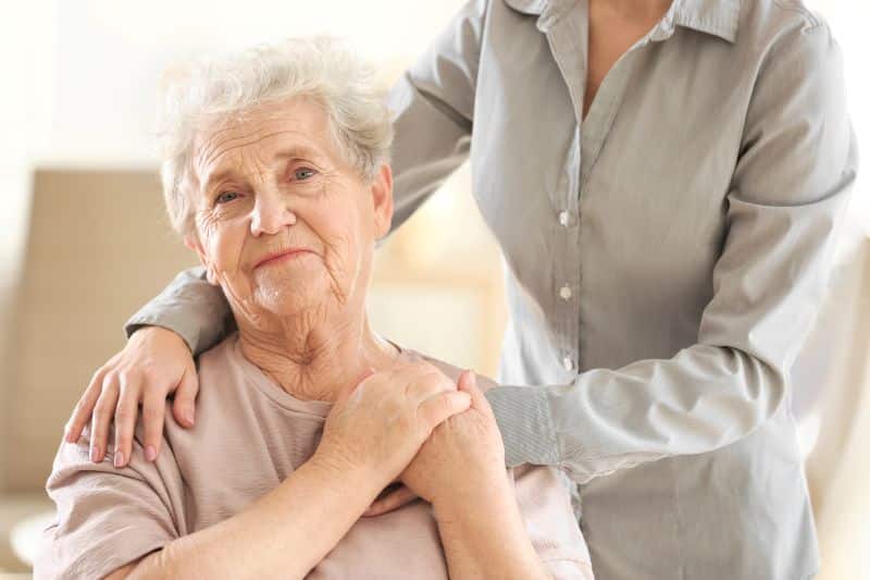 View of patient being hugged by family member