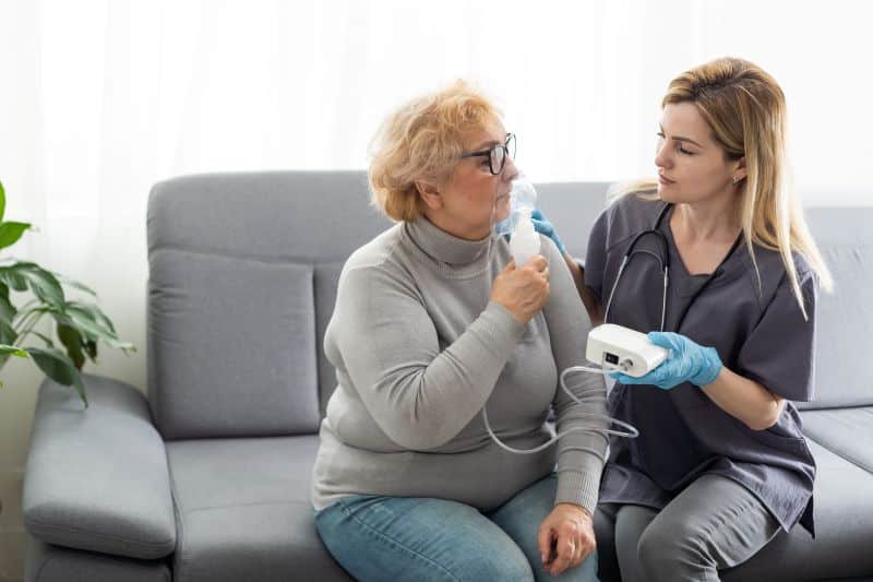 Nurse giving patient a breathing treatment