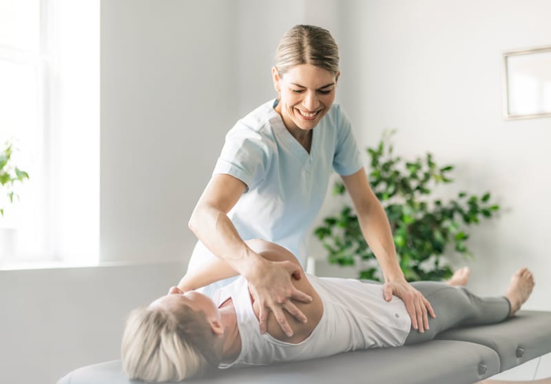 Rehabilitation physiotherapy professional working with a patient